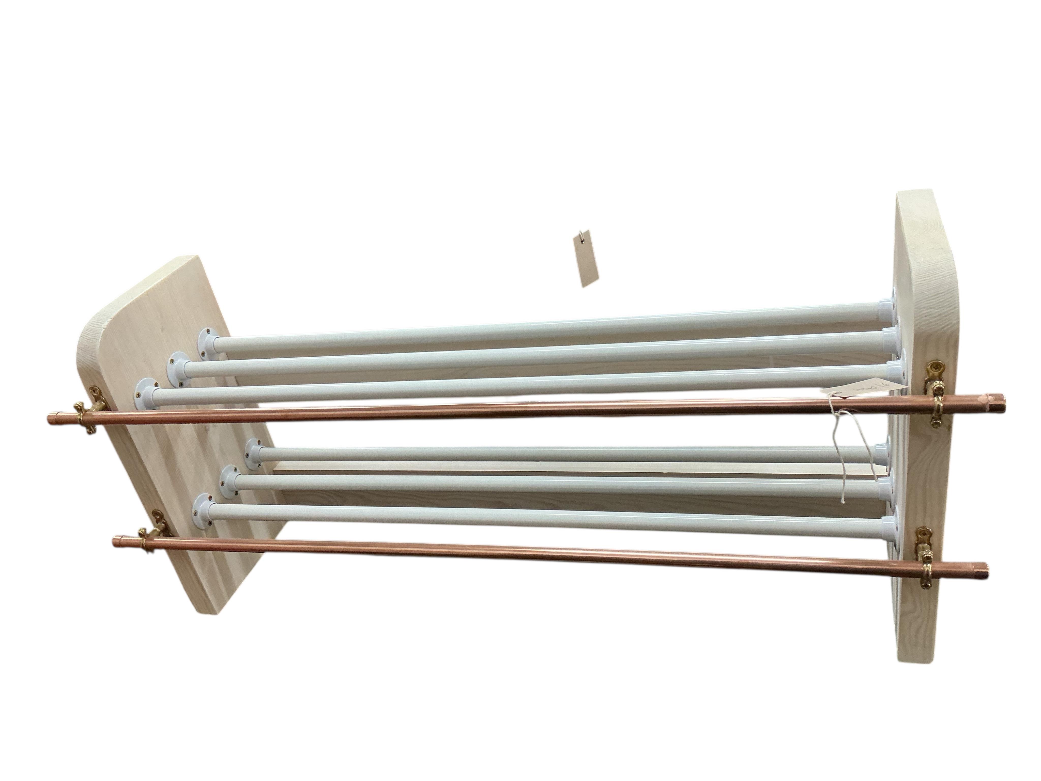 An industrial style painted wood and tubular copper shoe rack, width 93cm, depth 26cm, height 41cm